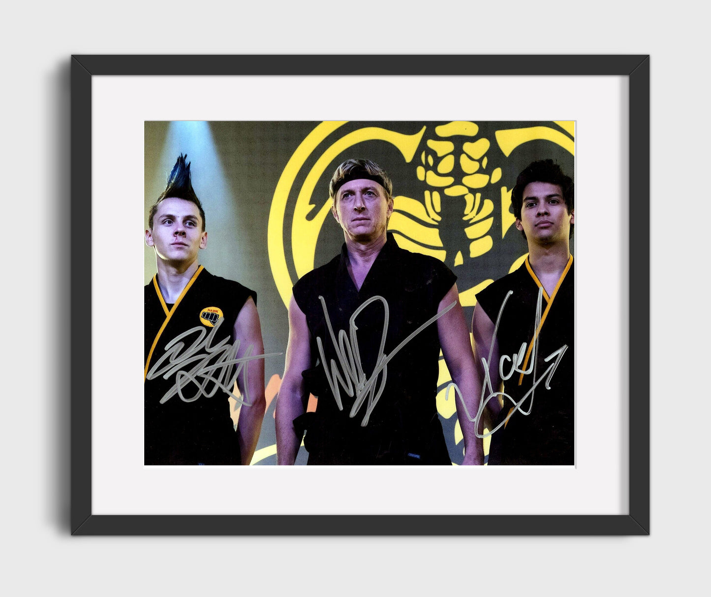 Cobra Kai - William Zabka (Johnny Lawrence) and Xolo Mariduena (Miguel Diaz) and Jacob Bertrand (Hawk) Cobra Kai Dojo Scene - Gallery Frame television wall art